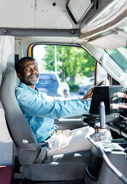 African American Driver smiling to welcome rider